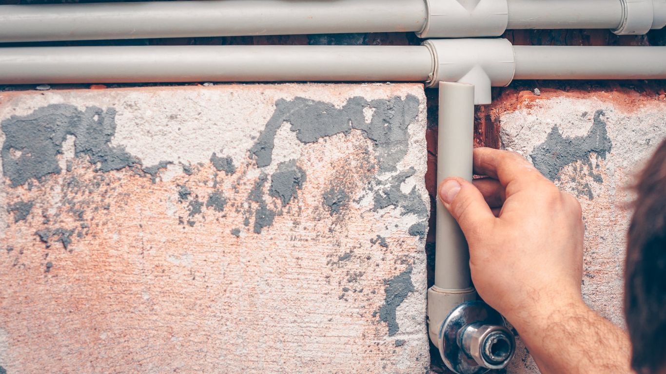 Technician fitting pipe for plumbing